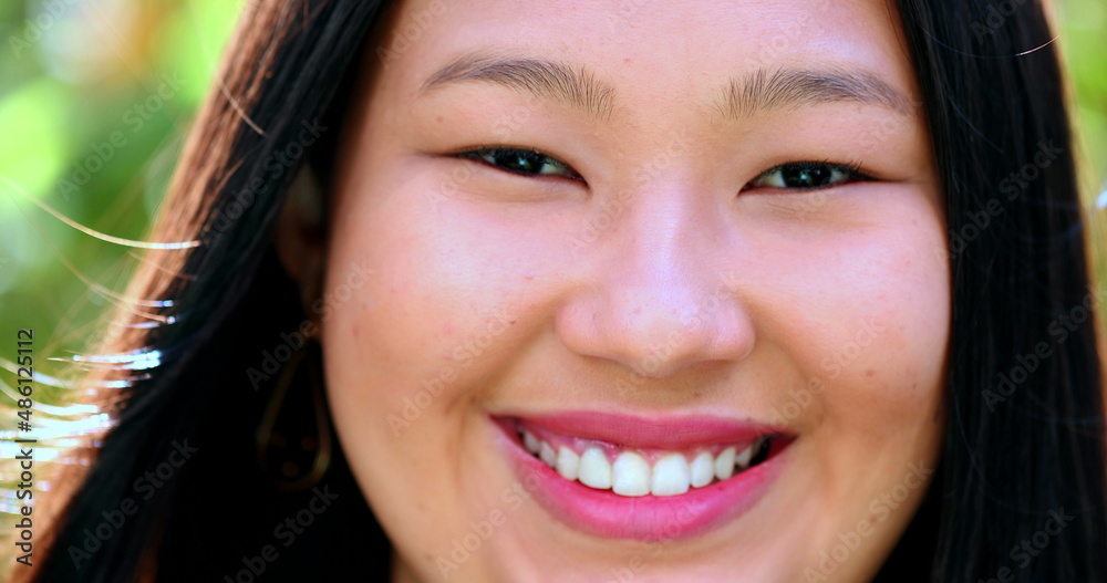 Happy young asian woman smiling at camera, close-up portrait face Happy young asian woman smiling at camera, close-up portrait face
