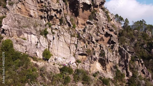 Aerial shot of climbers overcoming a difficult climbing route on the rock