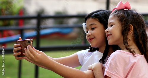 Canvas-taulu Children taking selfie with cellphone, pre-teen girls take selfie