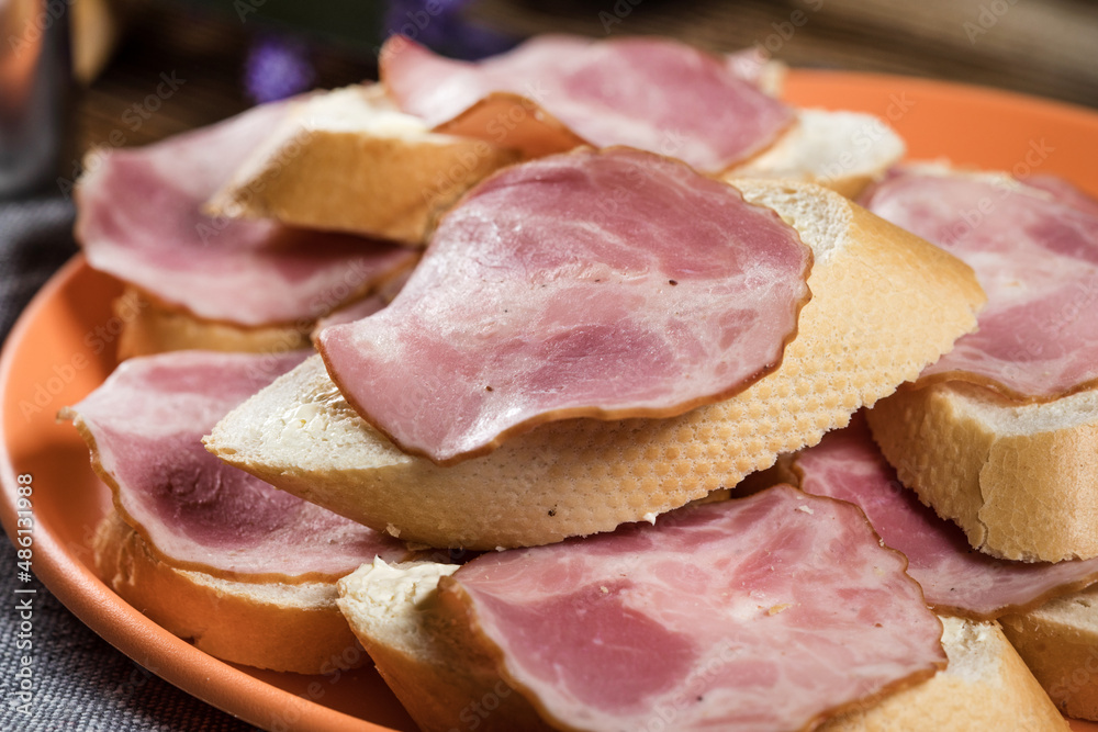 Sandwich made of wheat bread, butter and slices of dry-cured sausage. Sandwich made of wheat bread, butter and slices of dry-cured sausage.