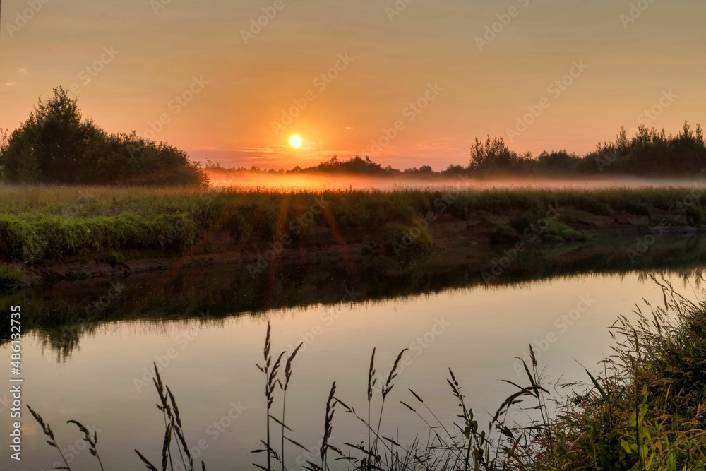 Fog on a guiet river at sunset