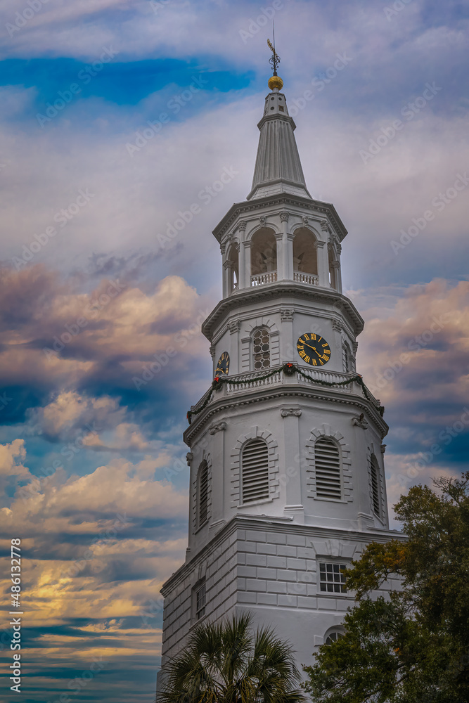 2022-02-09 A WHITE CHURCH STEPPLE WITH A GOLD AND BLACK CLOCK AND A SOFT BLUE SKY WITH CLOUDS IN SOUTH CAROLINA