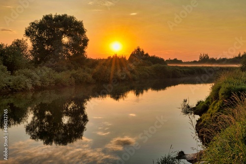 Fog on a guiet river at sunset photo