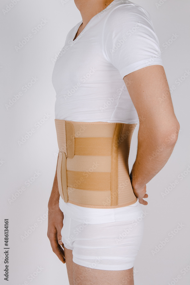 Orthopedic lumbar corset on the human body. Back brace, waist support belt  for back. Posture Corrector For Back Clavicle Spine. Post-operative Hernia  Pregnant and Postnatal Lumbar brace after surgery Stock Photo