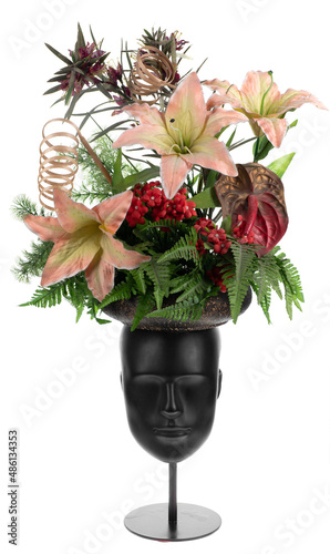 a bouquet of flowers on the head of a mannequin