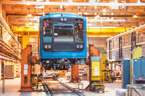 Passenger carriage locomotive of the subway, electric transport in the depot on suspended jacks for service maintenance.