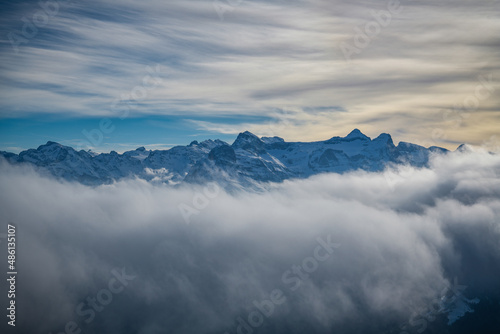 Snowy mountains hiding behind the clouds as seen from Fronalpstock peak