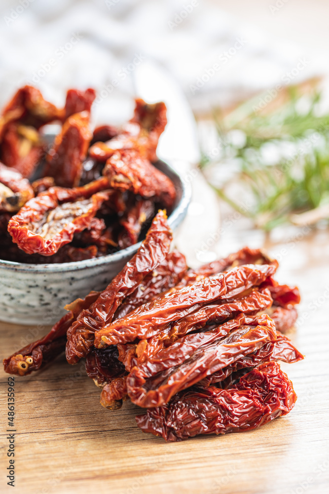 Sun dried tomatoes on wooden table. Sun dried tomatoes on wooden table.