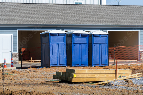 Three Porta Potties Or Outdoor Toilets At New Construction Site photo