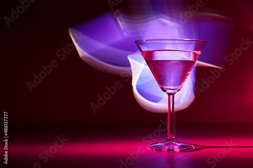 Martini cocktail drink in neon iridescent pink and blue colors.