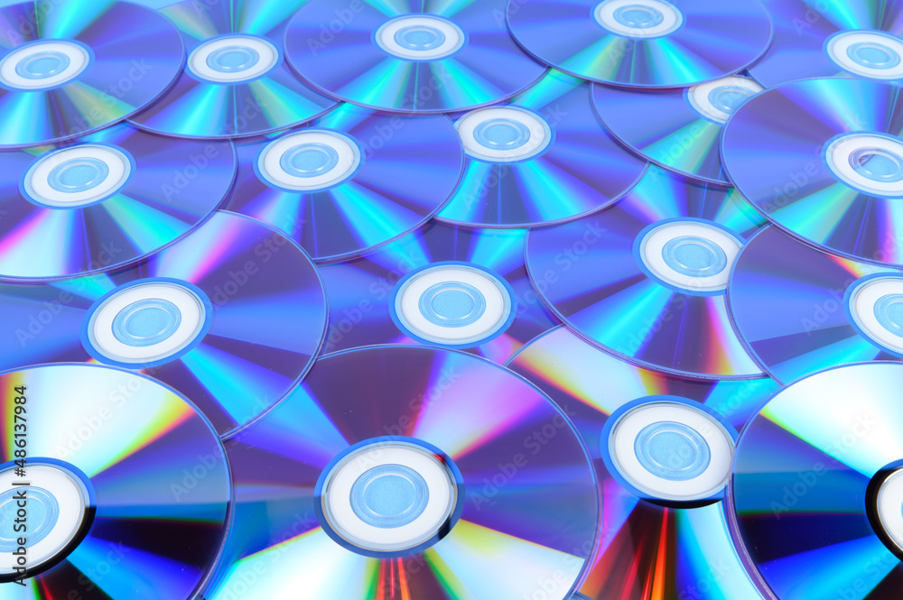 Several CDs are laid out on a horizontal surface Several CDs are laid out on a horizontal surface