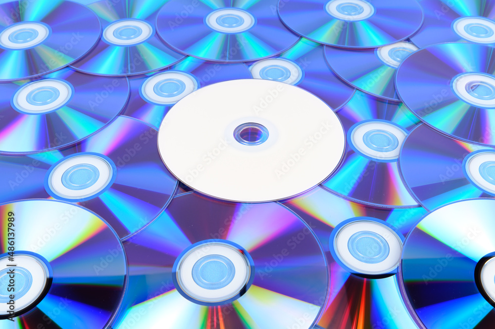 Several CDs are laid out on a horizontal surface Several CDs are laid out on a horizontal surface