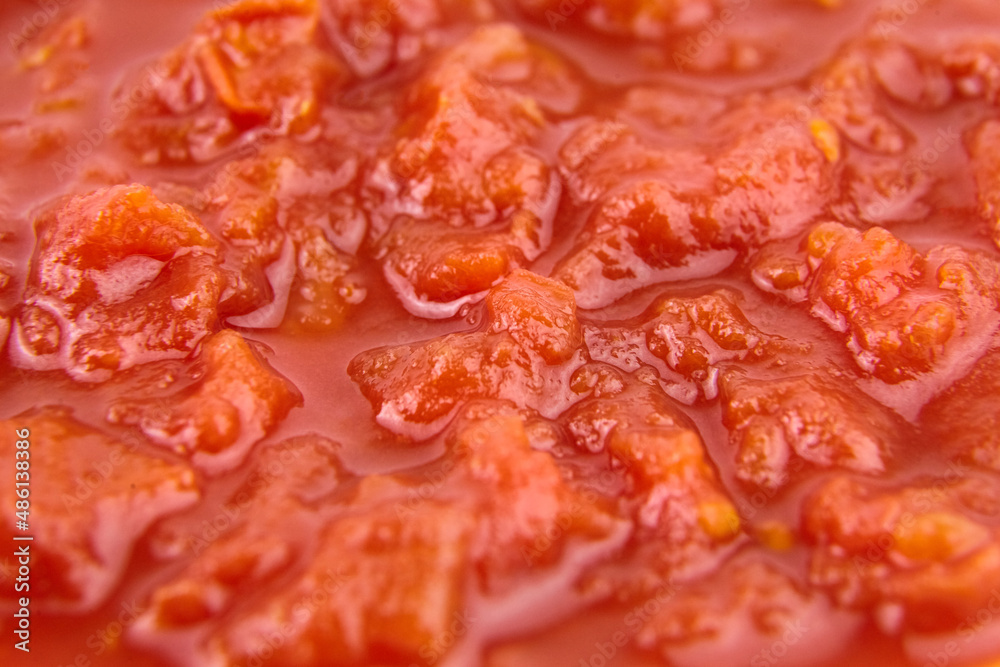 Chopped tomatoes in tomato juice food background