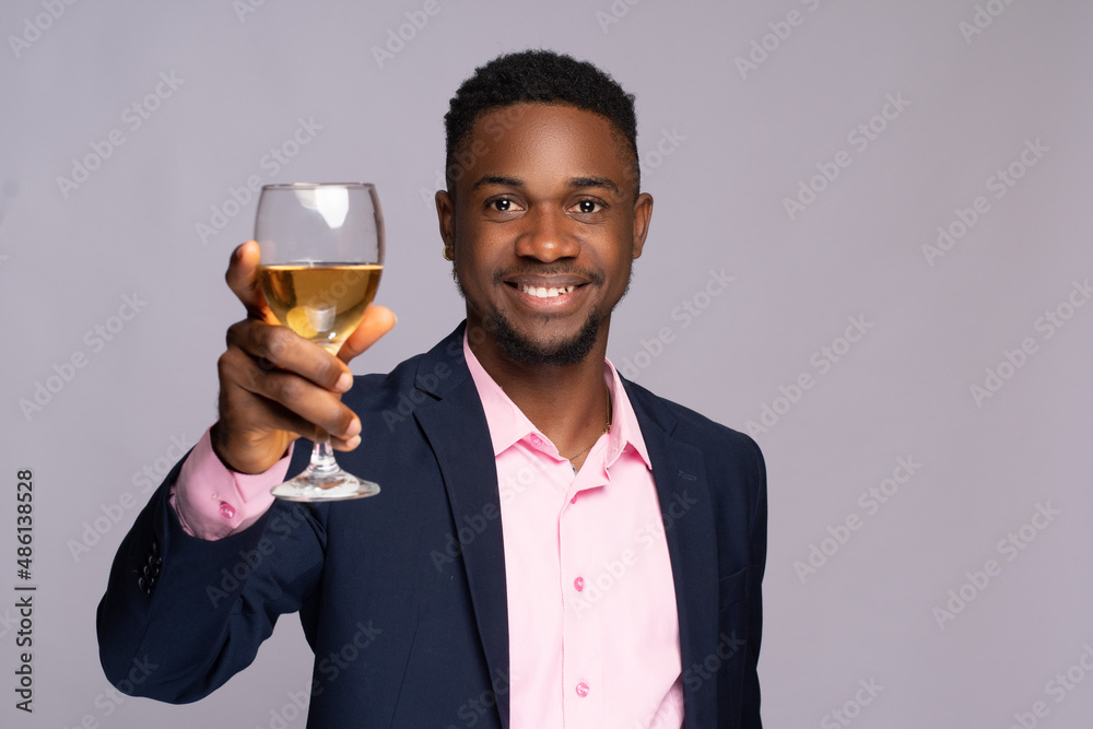 young black business man raising a wine glass young black business man raising a wine glass