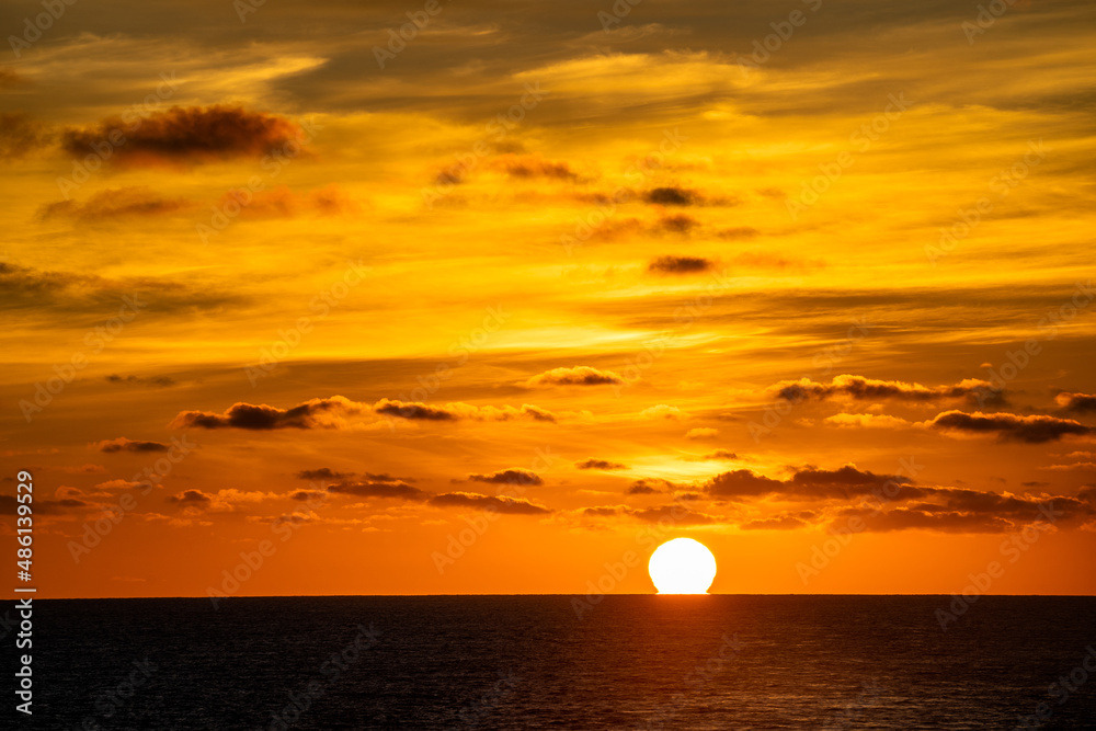 Orange sky at sunrise over the Pacific ocean 