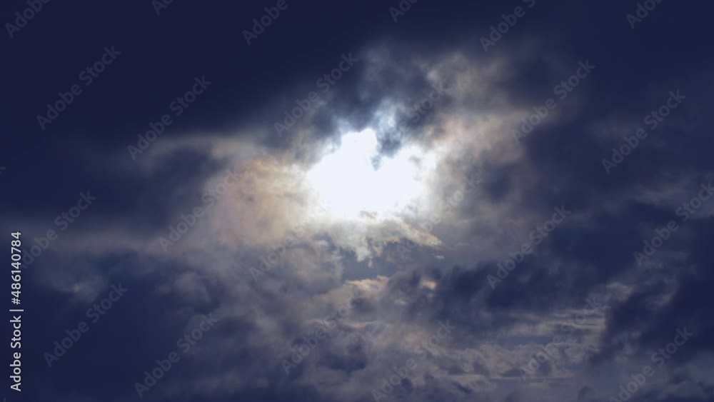 Amazing dark sky pierced by moonlight beams with spooky rotating clouds. Amazing dark sky pierced by moonlight beams with spooky rotating clouds.