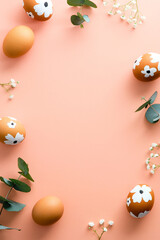 Happy Easter vertical banner design. Easter eggs and flowers on pastel pink background. Minimal style.
