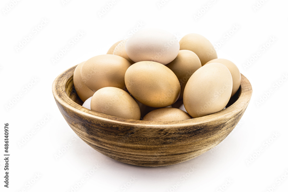 Brazilian free-range chicken eggs in rustic wooden bowl with white background and copyspace Brazilian free-range chicken eggs in rustic wooden bowl with white background and copyspace