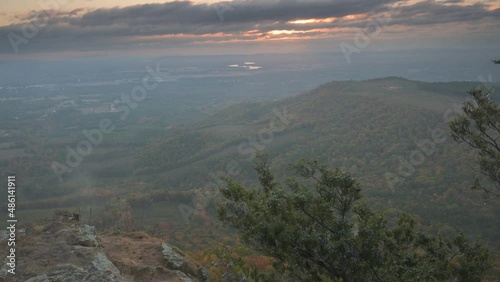 Foggy morning with sun rays breaking the clouds over the Ozark mountains of Arkansas.