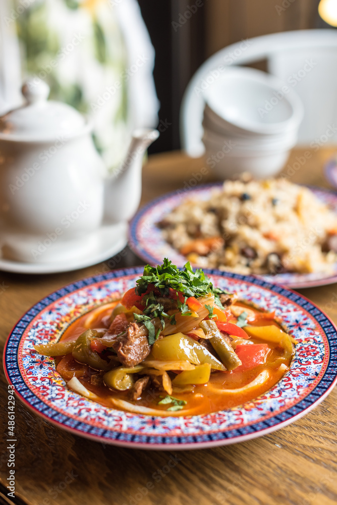 Central Asian Noodle Soup or Stew Lagman with Lamb Meat and Vegetables Garnished with Fresh Parsley