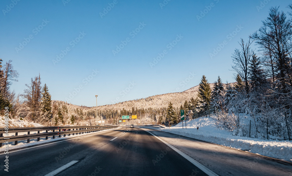 Snow covered  forest next to highway passing through the montain region of Gorski Kotar, Croatia
