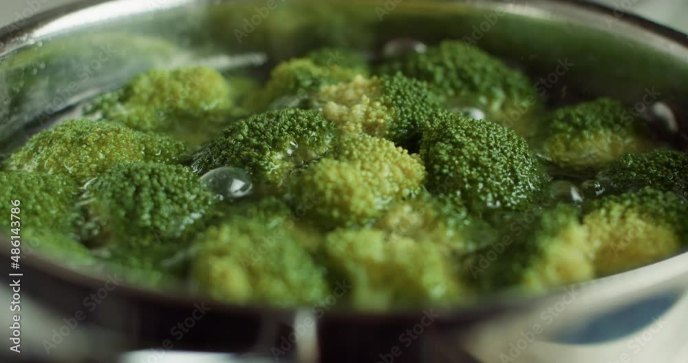 Organic Broccoli Heads boiling in a bow. Cooking healthy food Organic Broccoli Heads boiling in a bow. Cooking healthy food