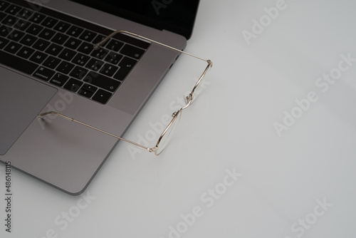 Gold Eyesglasses workspace and white background photo