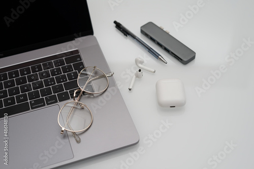 Macbook pro, eyerglasses and Work accessories on white background