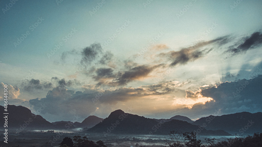 Morning view of mountain landscape with fog on sky and clouds background in Phatthalung province, Southern of Thailand.
