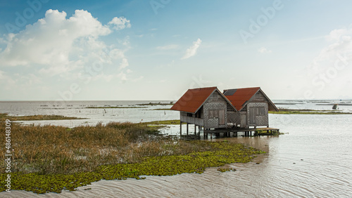 Landscape of twin old house on wetland at Talay Noi lake Phatthalung province in southern of Thailand.