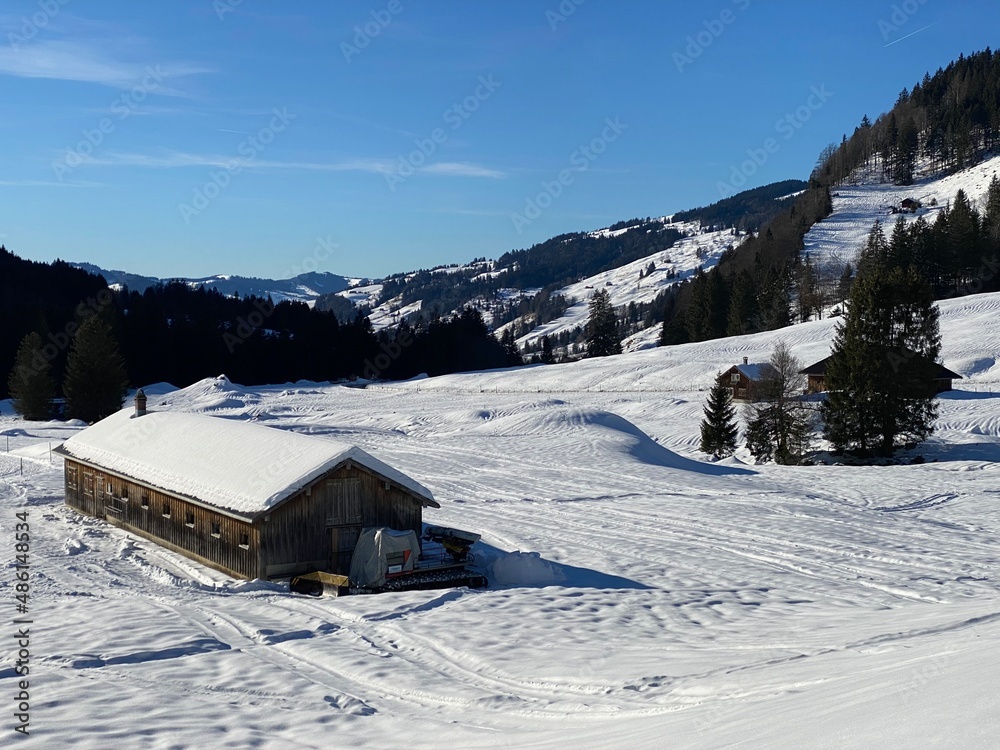 Idyllic Swiss alpine mountain huts dressed in winter clothes and in a fresh snow cover on slopes on the Alpstein mountain range - Mountain pass Schwägalp, Switzerland (Schweiz)