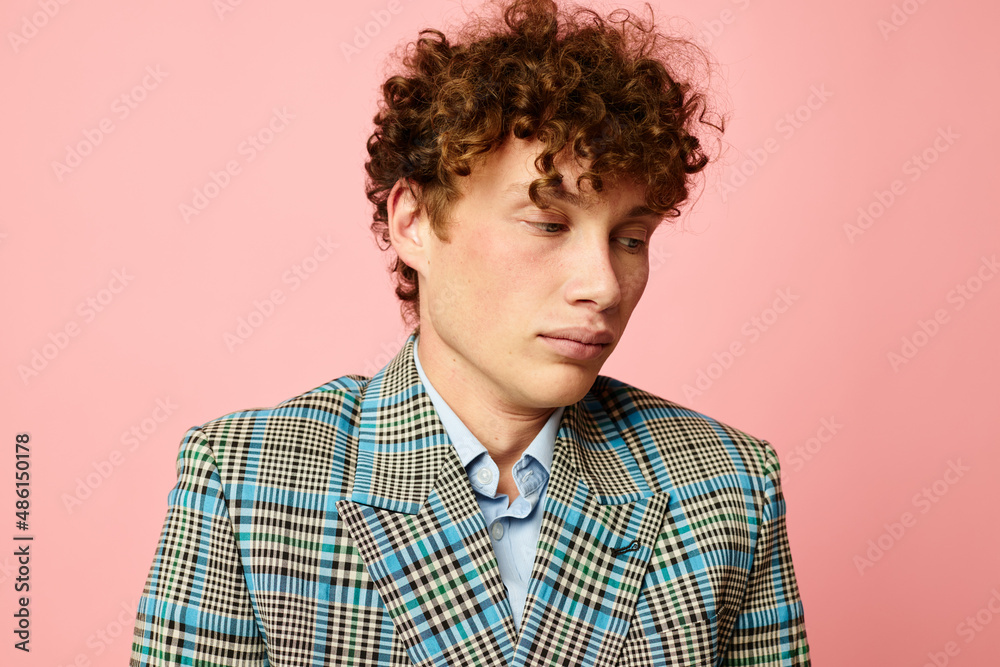 Young curly-haired man gesturing with his hands emotions checkered jacket Lifestyle unaltered Young curly-haired man gesturing with his hands emotions checkered jacket Lifestyle unaltered