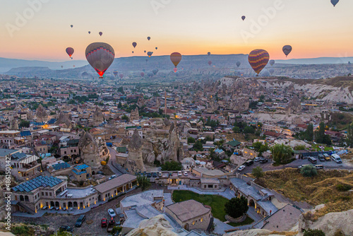 Early morning aerial view of hot air balloons above Goreme village in Cappadocia, Turkey