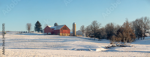 Amish Farm with Red Barn Sitting on a Snow Covered Hill In Holmes County, Ohio