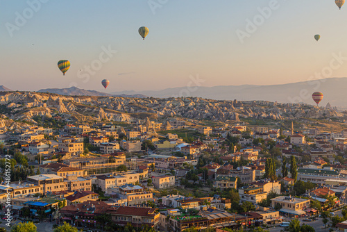 GOREME, TURKEY - JULY 21, 2019: Hot air balloons above Goreme village in Cappadocia, Turkey