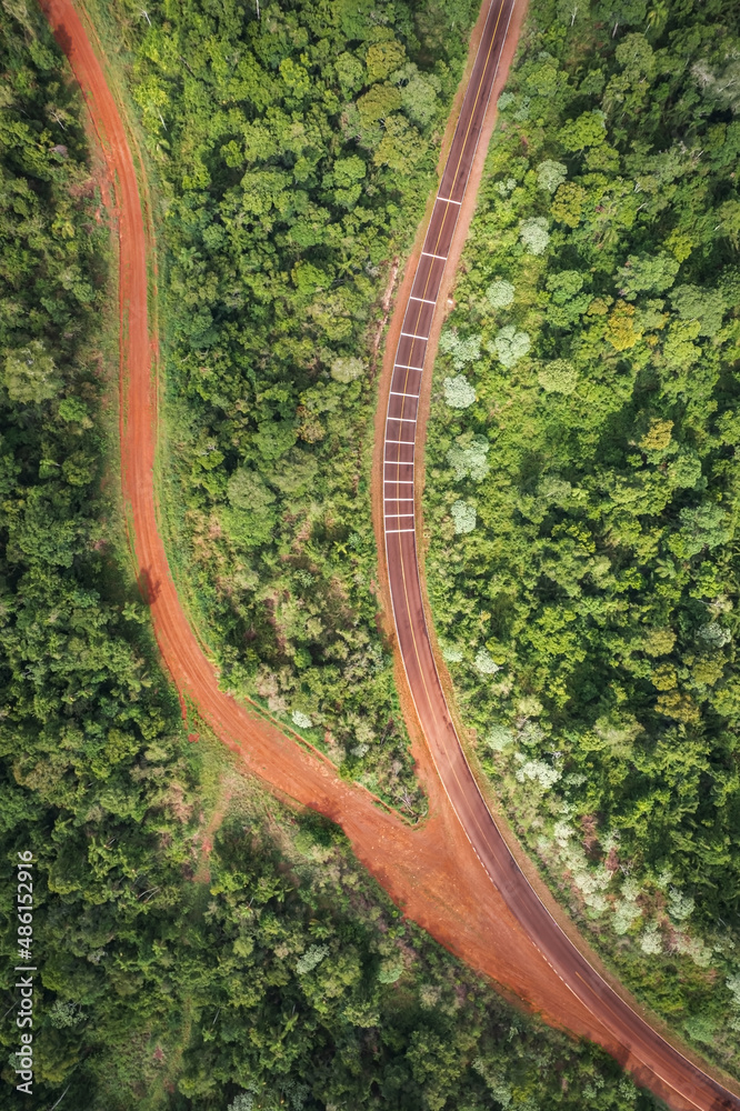 red dirt road and paved road in the middle of the Misiones jungle of Argentina