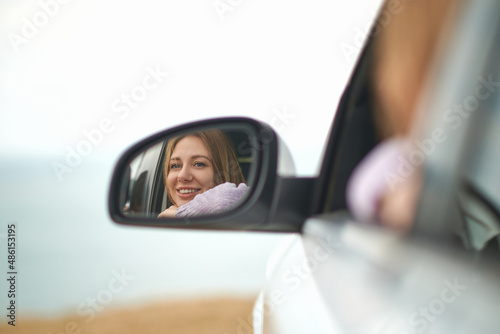girl in mirror of car