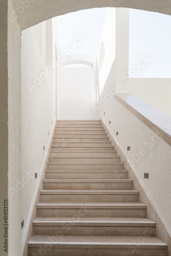 Arabic style architectural details with steps and archway. Staircase with railing going up. 