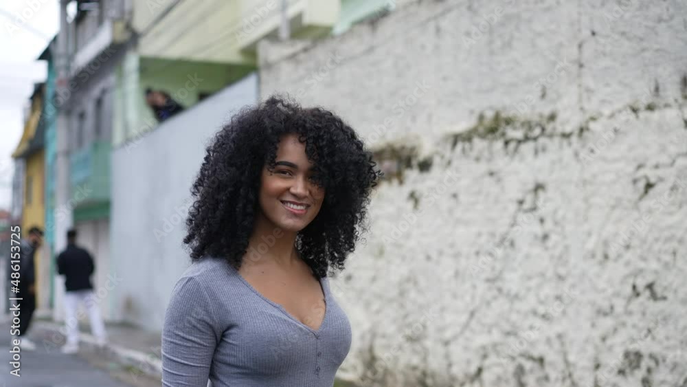 A happy diverse young black woman turning to camera smiling A happy diverse young black woman turning to camera smiling