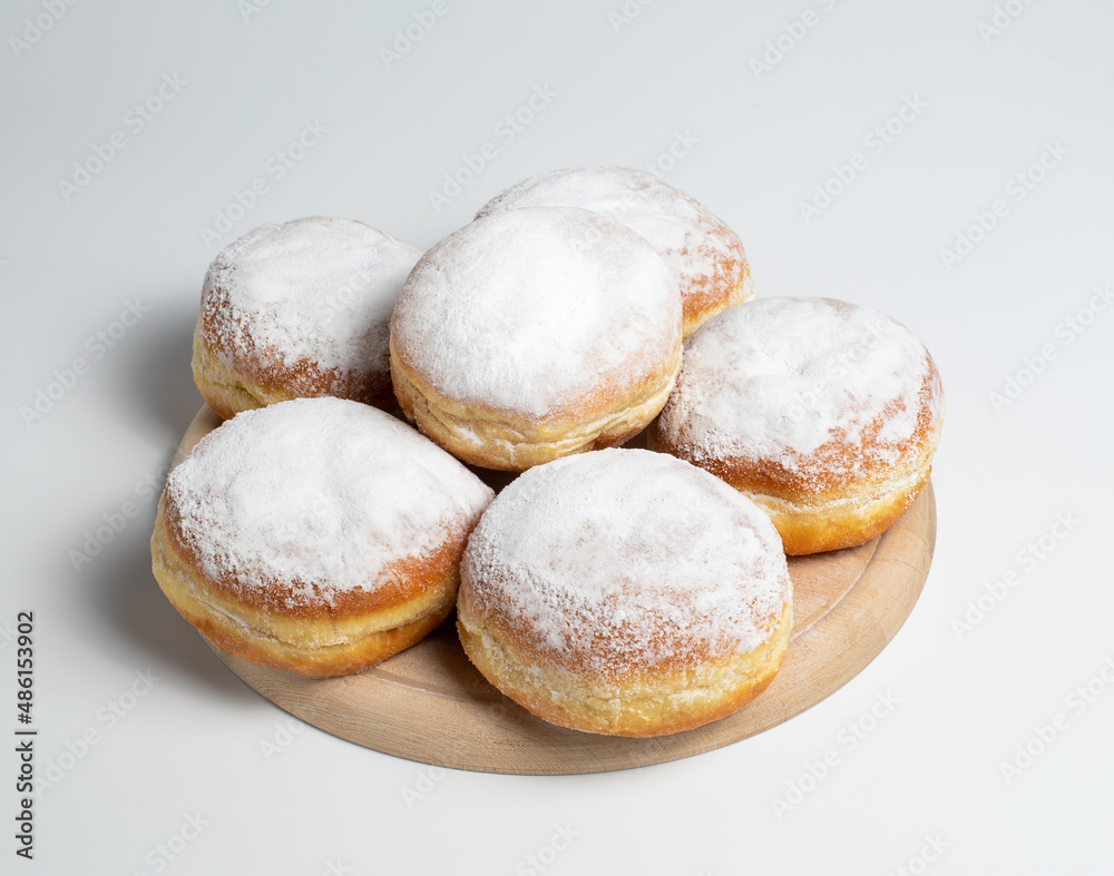 Austrian and german donuts or krapfen.  Faschingskrapfen. Berliner with cream. On wooden background. Selective focus.