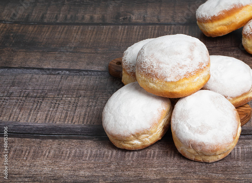 Austrian and german donuts or krapfen.  Faschingskrapfen. Berliner with cream. On wooden background. Selective focus.