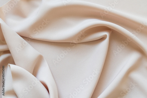 Abstract beige cloth texture background with folds. Copy space. 