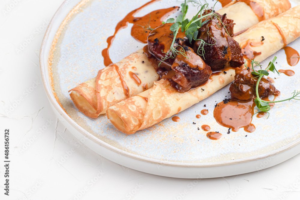 Pancakes with meat, pancakes with beef on a white background, Russian cuisine Pancakes with meat, pancakes with beef on a white background, Russian cuisine