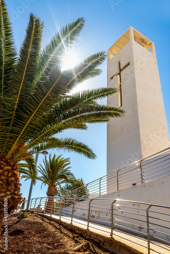 Bell tower of the church in Morro Jable in the rays of the sun 