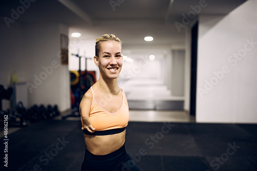 Happy armless athletic woman exercising in health club and looking at camera. photo