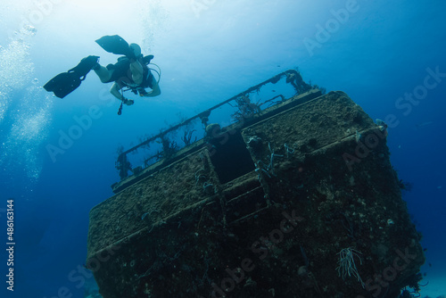 divers enjoying a deep wreck ship © Cavan