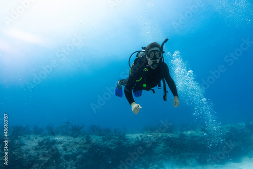 diver surprised by the coral reef