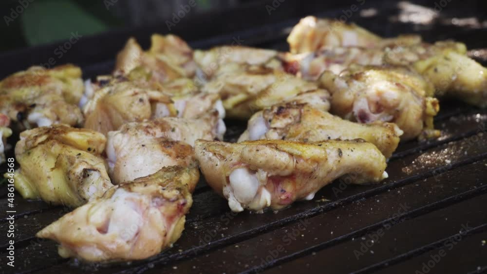 closeup of several pieces of chicken and thighs frying on a grill in a country house in the daytime in 4k closeup of several pieces of chicken and thighs frying on a grill in a country house in the daytime in 4k