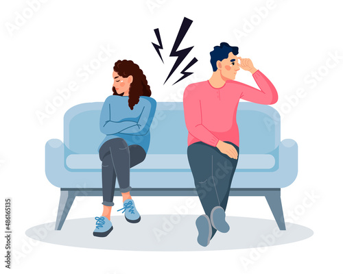A young married couple has problems in their relationship. A woman and a man are sitting on the couch and don't want to talk to each other. The concept of a family quarrel, divorce. Domestic conflict