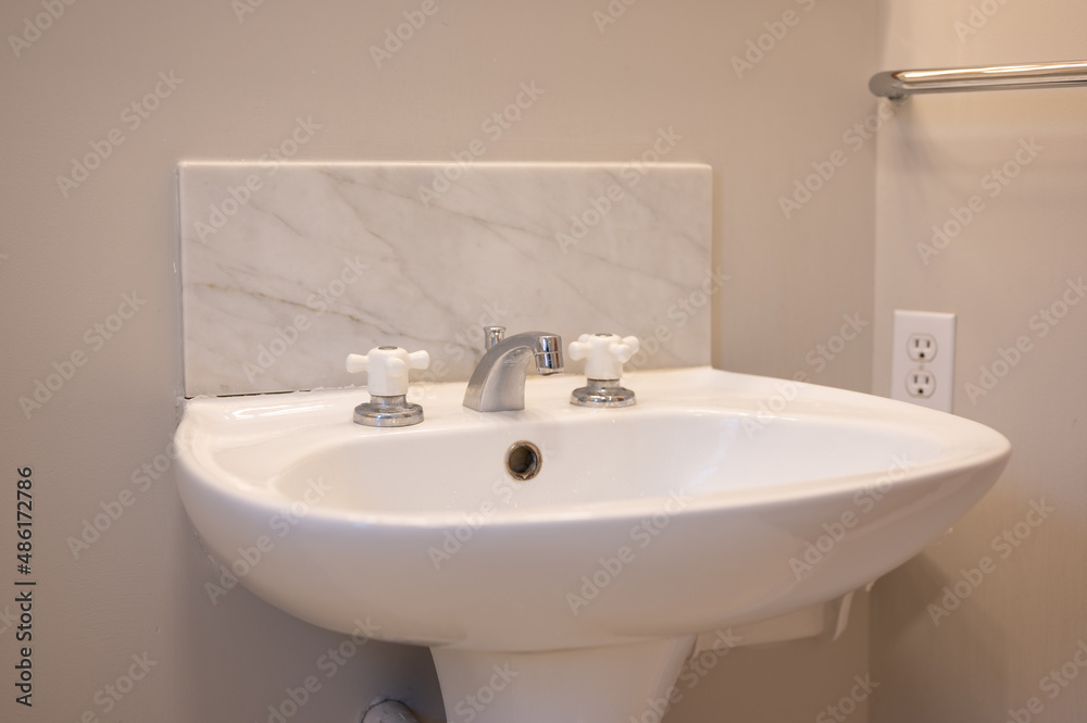 Fototapeta premium Bathroom sink with marble background 